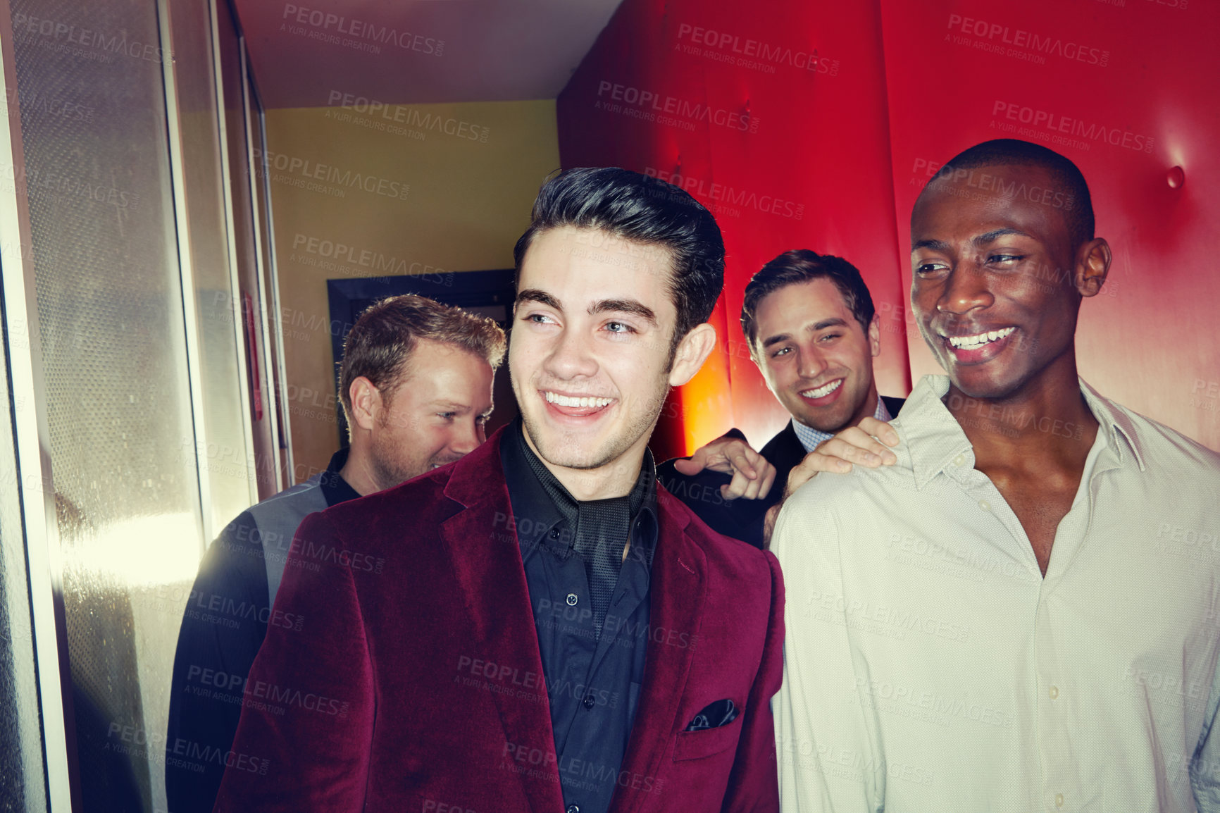 Buy stock photo A group of smartly dressed men arriving at a nightclub together