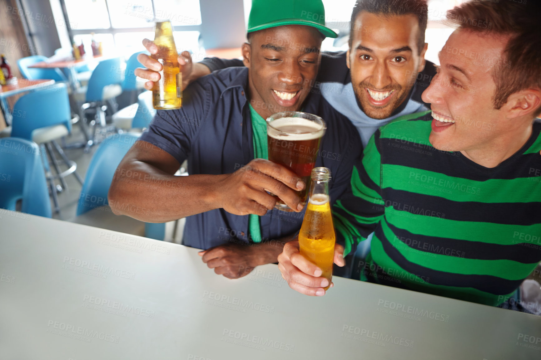Buy stock photo Toast, fans or excited people in pub with beer, team or social celebration of football competition and score. Happy men, soccer game event and friends hug in bar for fun party, alcohol and support