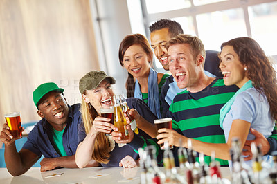 Buy stock photo A group of excited friends cheering on their favourite team at the bar