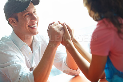 Buy stock photo Happy couple, holding hands and laugh at cafe for love, bonding or care with funny joke in morning. Man, woman and support with conversation, connection and smile for memory with trust at coffee shop