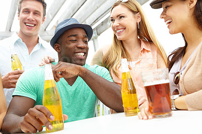 Buy stock photo A group of friends enjoying drinks on the deck of a trendy outdoors restaurant