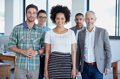 Buy stock photo Shot of a group of happy coworkers standing in an office