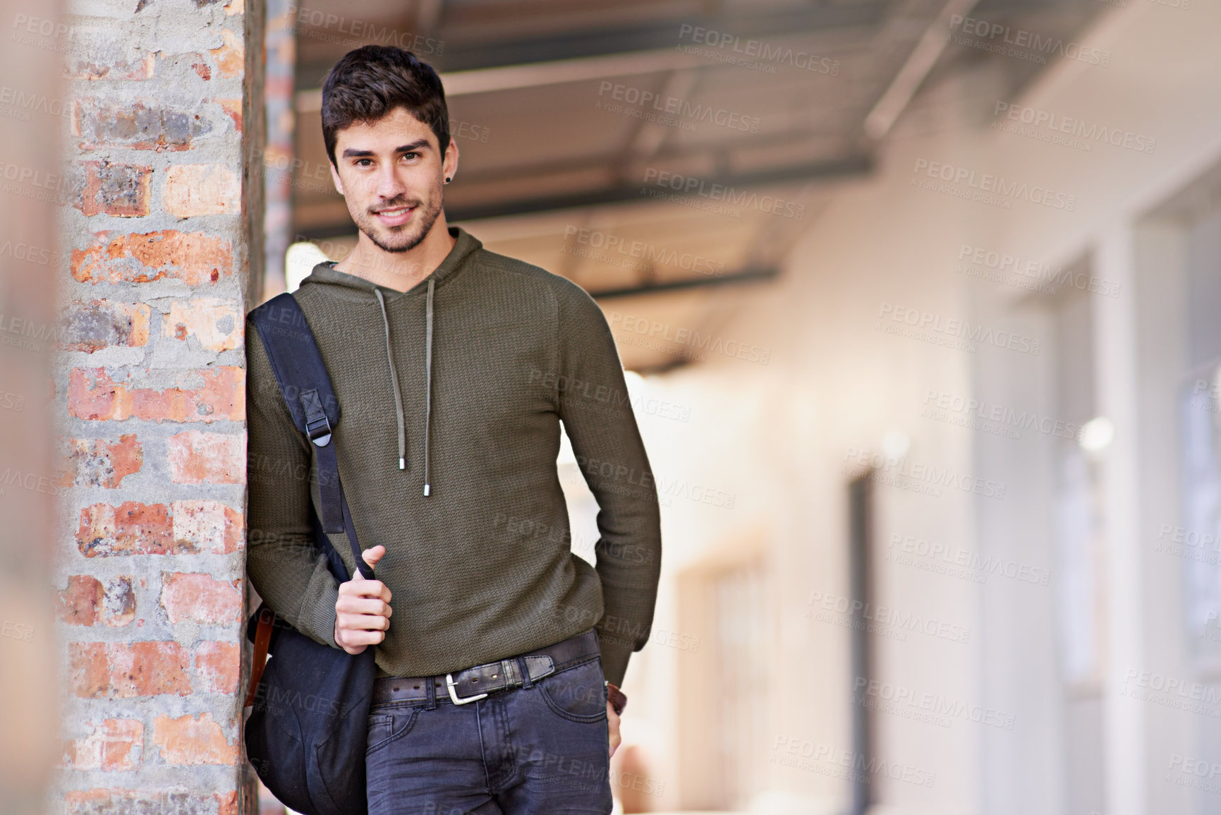 Buy stock photo Male college student, smile and portrait on campus or university for education, higher learning or study. Young guy, happy and standing outdoor with bag for educational class with mockup space