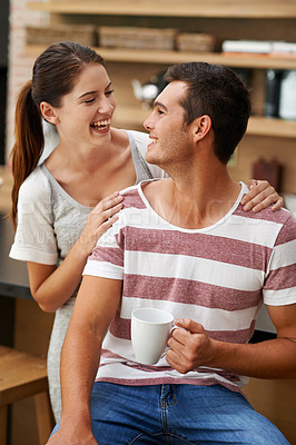 Buy stock photo Funny, couple and relax in home with coffee in morning for energy, benefits and happiness. Woman, support and care for partner with preparation of drink in kitchen with espresso, latte and love