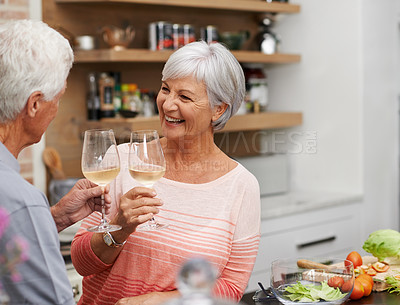 Buy stock photo Old couple, toast and happiness in kitchen with wine for retirement, celebration and cooking in apartment. Senior woman, and vacation for love, commitment and wellness in modern house for holiday.
