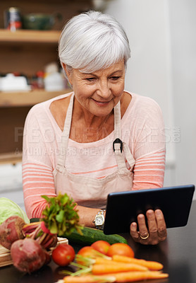 Buy stock photo Senior woman, tablet and vegetables for cooking wholesome, healthy and nutritional food at home. Retired lady, ingredients and digital device for researching diet, recipes and delicious vegan meals