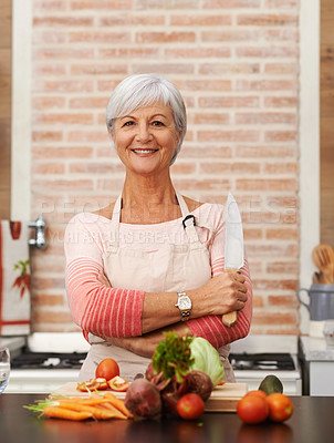 Buy stock photo Senior woman and cooking with knife in kitchen or confident, tomato or carrots for diet. Female chef or portrait with healthy vegetables for nutrition, green lettuce and onion in retirement home