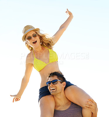 Buy stock photo Man, smiling and woman excited on shoulders for summer break, vacation or holiday together. Couple, happy and in love travelling for romantic trip, relaxed beach date and bonding in sunlight