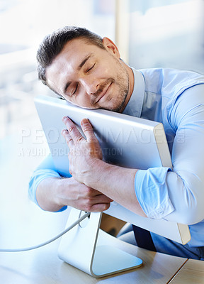 Buy stock photo Shot of a smiling businessman hugging his monitor warmly