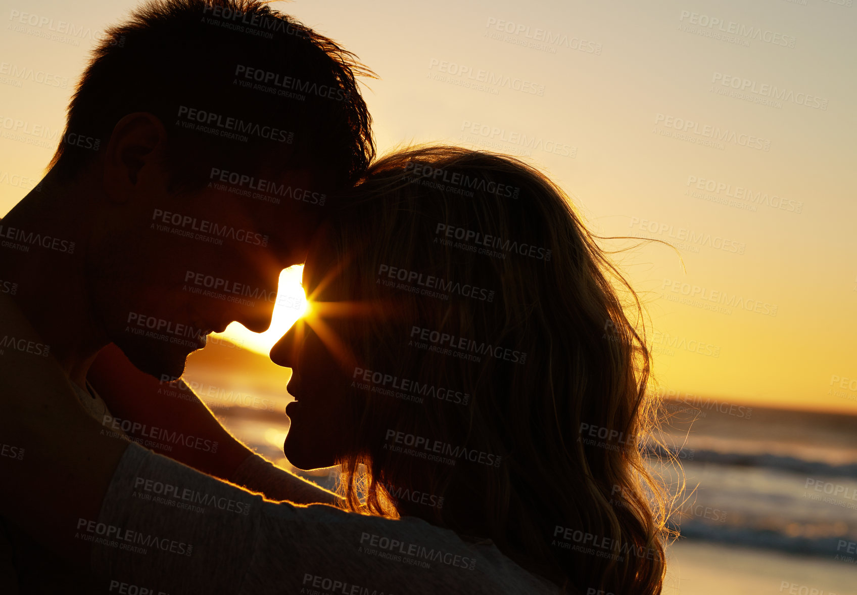 Buy stock photo Relationship, love and kissing at beach with sunset for date or summer holiday and bonding in Florida. Couple, commitment and romance together as soulmate with smile, fun and hug or forehead touch
