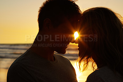 Buy stock photo Couple, love and kiss at beach with silhouette for date or summer holiday and bonding in Florida. Relationship, commitment and romance together as soulmate with smile, vacation and honeymoon sunset 