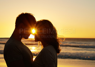 Buy stock photo Couple, romance and kiss at beach with sunset for date or summer holiday and bonding in Florida. Relationship, commitment and love together as soulmate with smile or happy for honeymoon and vacation 