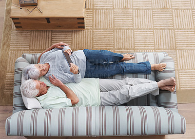 Buy stock photo Top view, senior couple and sofa with tablet, social media, online news app and ebook in lounge. Happy old man, woman and relax with digital technology, subscription or website on internet connection