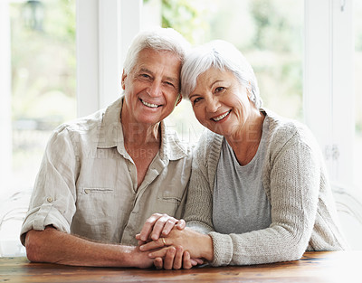Buy stock photo Senior, happy couple and portrait holding hands for love, romance or embrace in relationship or marriage at home. Face of elderly woman and man with smile for care in retirement or bonding together