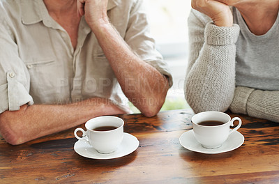 Buy stock photo Cropped image of a senior couple enjoying a cup of tea together