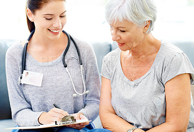 Buy stock photo Health, checklist and senior woman care with nurse for insurance and medical consultation. Elderly female patient, healthcare worker and smile in a hospital and clinic with medic paperwork and help