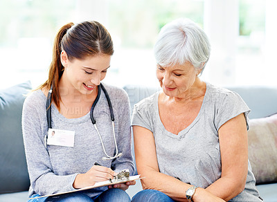 Buy stock photo A doctor explaining positive test results to a smiling senior patient