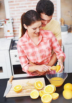 Buy stock photo Couple, kitchen and happy with orange for juice in bowl for health, nutrition and diet with ingredients. Home, relationship and bonding with fruit for sweet flavor or lunch snack and fresh food