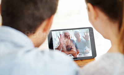 Buy stock photo Happy couple, tablet and video call with grandparents for greeting or online conversation at home. Rear view of man and woman talking or waving with technology for virtual meeting or communication