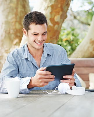 Buy stock photo Smile, park and man with tablet in nature on table for networking, email and freelance job. Happy, digital nomad and graphic designer with tech in garden for creative research, feedback and review