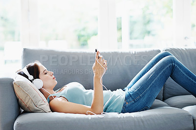 Buy stock photo Girl, headphones and phone on sofa in house for music, relax and self care while on study break. Woman, headset and smartphone on couch in home living room for social media, video and app or radio