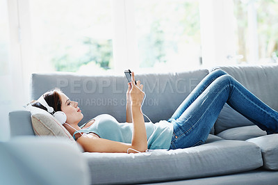 Buy stock photo Woman, headphones and phone on sofa in house for music, relax and self care while on study break. Girl, headset and smartphone on couch in home living room for social media, video and app or radio