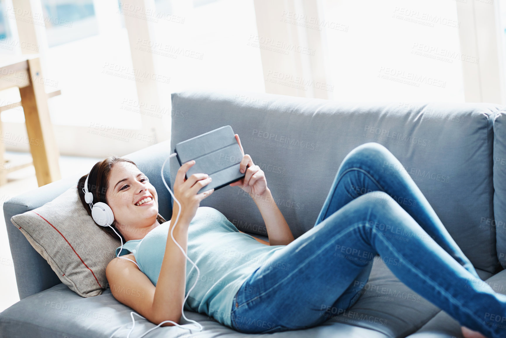 Buy stock photo Girl, headphones and tablet on sofa in house for music, streaming and self care while on study break. Woman, headset and tech on couch in home living room for social media, video and app or radio