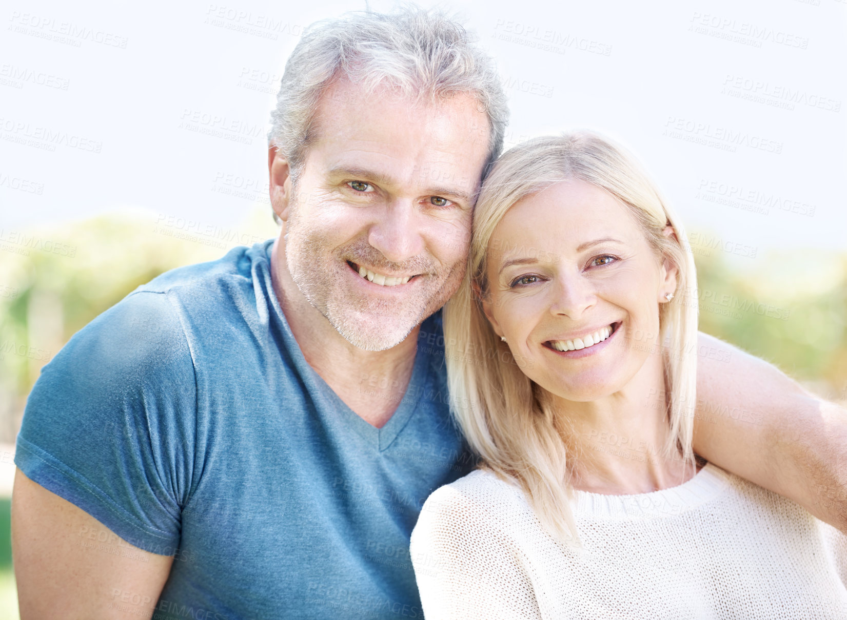 Buy stock photo A happy mature couple smiling at you outdoors