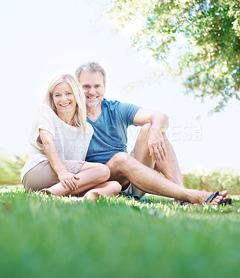 Buy stock photo Senior, happy couple and portrait with relax on grass field for bonding, love or hug in outdoor nature. Man and woman with smile on lawn for embrace, care or support in relationship or retirement