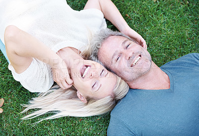 Buy stock photo Mature, couple and laugh on grass or married connection for travel holiday on anniversary, date or bonding. Man, woman and from above or laughing for funny joke with humor together, field or summer