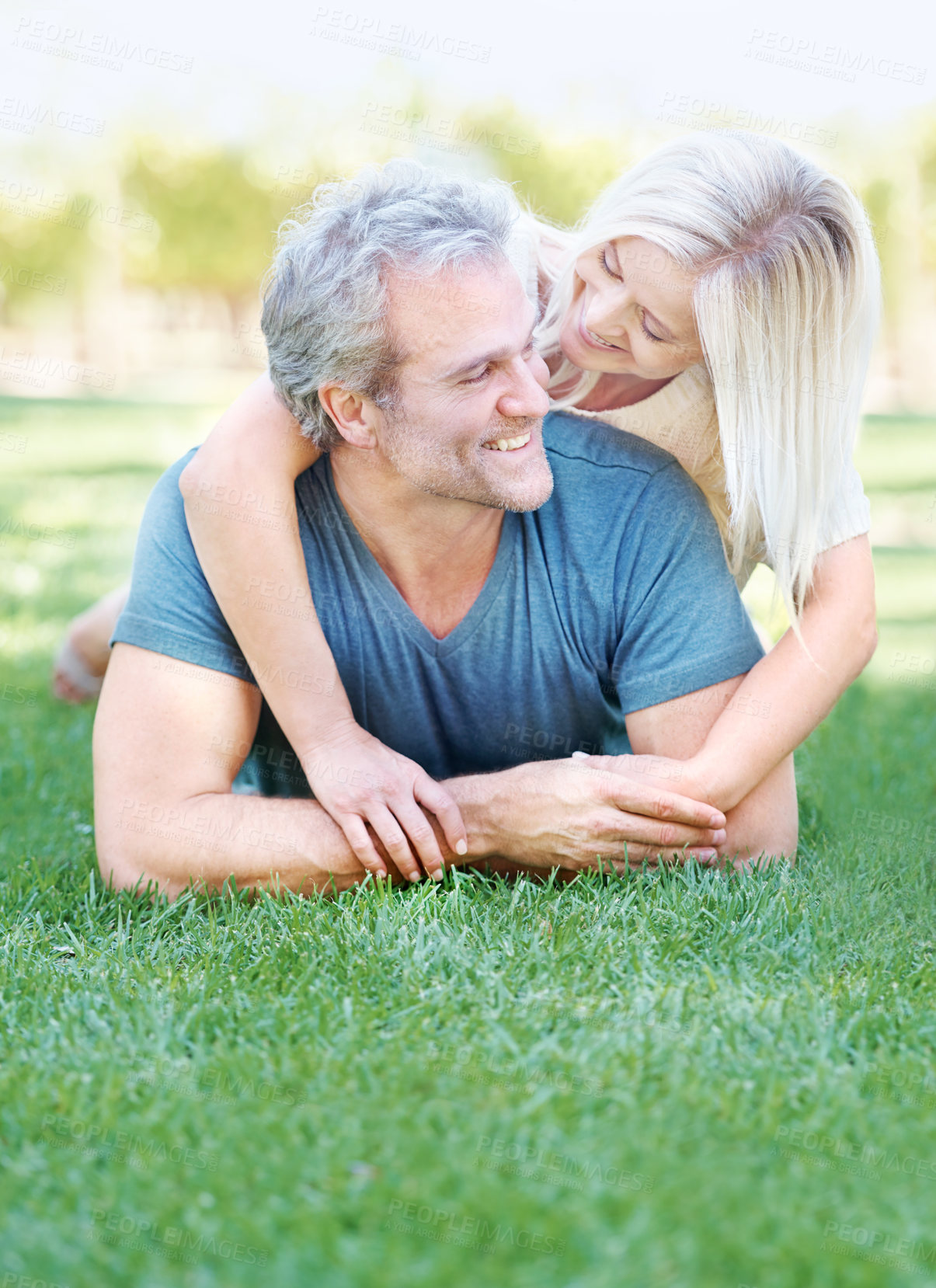 Buy stock photo Happy, grass and senior couple in park for bonding, relationship and commitment outdoors on weekend. Love, retirement and mature man and woman embrace for romance, relaxing and marriage in nature
