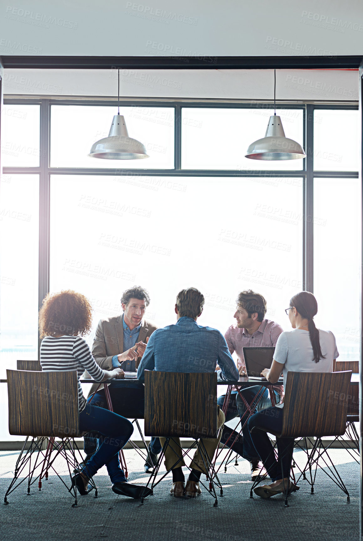 Buy stock photo Shot of a group of coworkers having a brainstorming session in an office boardroom