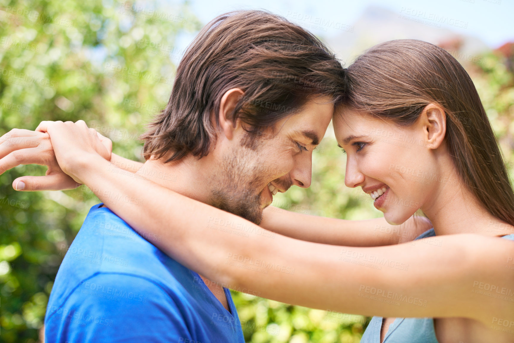 Buy stock photo Couple, admiration and nature together for relationship, bonding love and caring look or outside date for romance. Blue sky, trees and summer holiday, happy and smile for quality time with partner