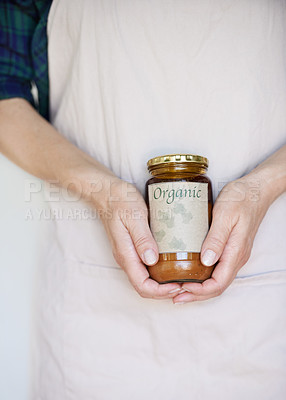 Buy stock photo Hands, product and person with organic jam for biodiversity,  sustainability and eco friendly in home. Preserver, apron and natural fruit spread for health, quality and wellness on white background