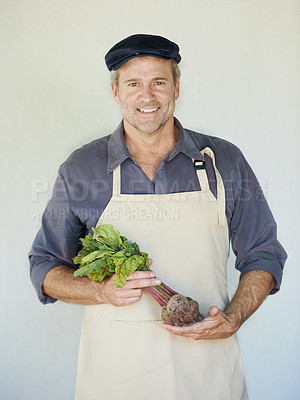 Buy stock photo A mature man holding a bunch of beetroot