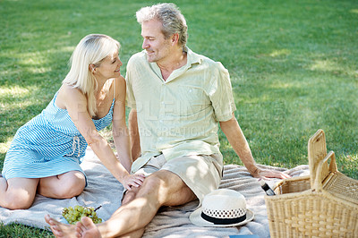 Buy stock photo Happy, smile and couple on picnic in park for anniversary, adventure and holiday together. Man, woman and love on blanket at countryside for marriage, bonding and outdoor romance in New Zealand