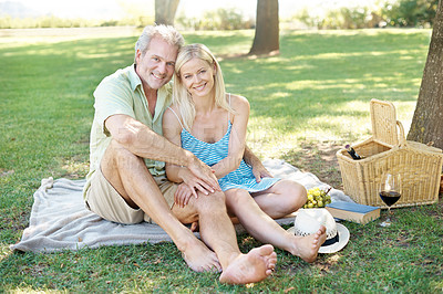 Buy stock photo Happy couple, portrait and relax with picnic at park for outdoor date, lunch or weekend on grass field. Man and woman with smile, basket and blanket for summer holiday, bonding or romance in nature