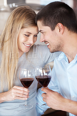 Buy stock photo A couple in love enjoying a glass of red wine