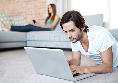 Buy stock photo Home, laptop and man on floor, typing and connection with internet, website information and online reading. Person, apartment and guy with pc, research and relaxing with computer and digital game