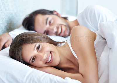 Buy stock photo Portrait, relax and sleep with couple in bed at home together for morning or weekend time off. Face, happy or smile with man and woman in bedroom of apartment for break, comfort or rest on vacation