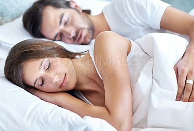 Buy stock photo Sleeping, man and woman in bedroom for peace, dreaming and cuddle in apartment. Couple, love and rest together at home for relaxation, comfort and trust in relationship or sleep in on weekend in bed