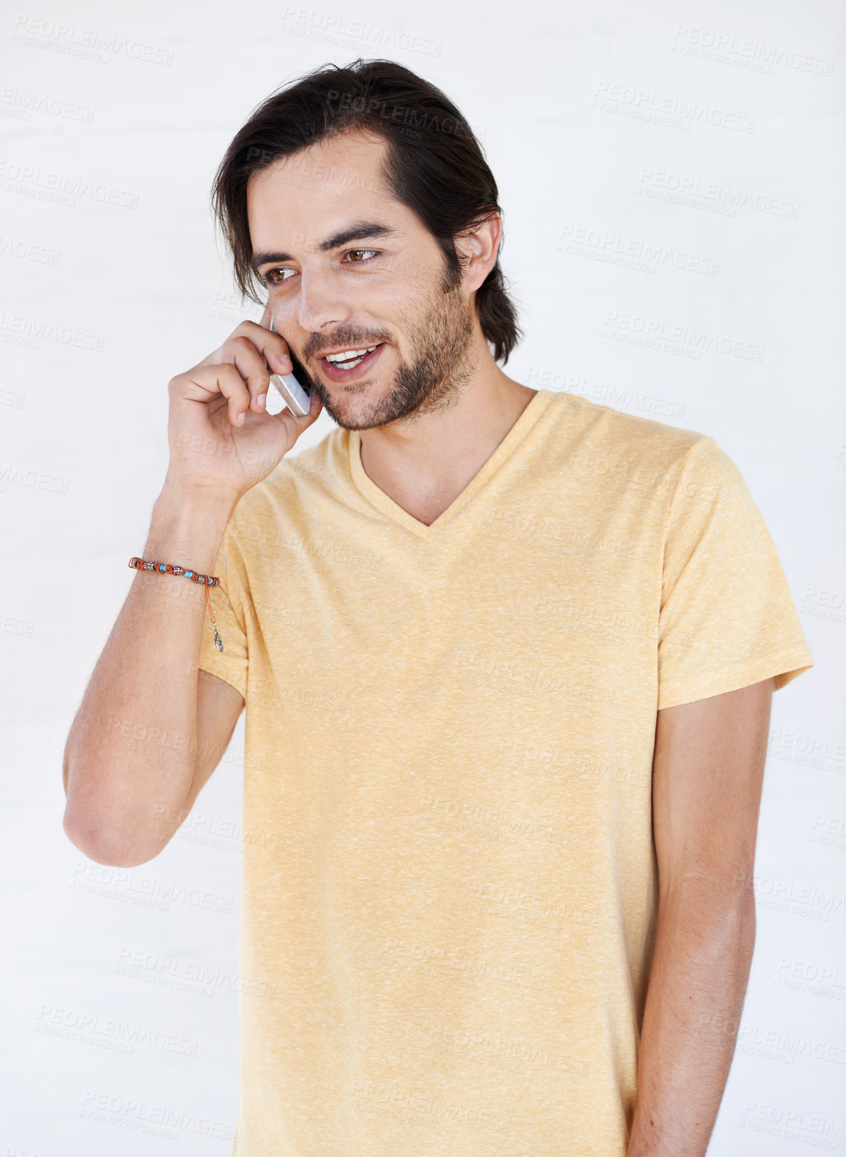 Buy stock photo Phone call, talking and man in studio, happy and relax while standing on white background space. Young, phone and hand guy enjoying casual call, conversation and speaking while chilling and isolated