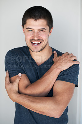 Buy stock photo Handsome young man standing against a grey background with a smile