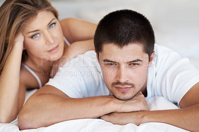 Buy stock photo Attractive young couple lying in bed together
