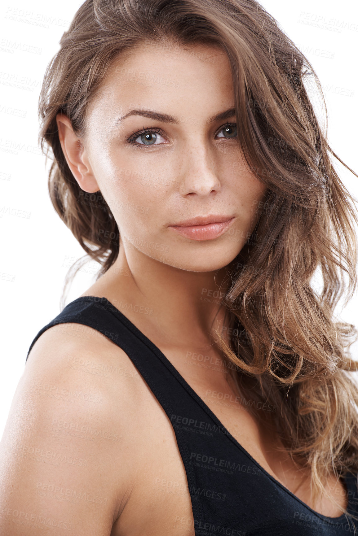 Buy stock photo Portrait of a beautiful sensual woman isolated on a white studio background. Young female model with brown brunette curly hair and clear radiant skin promoting skincare and beauty concept