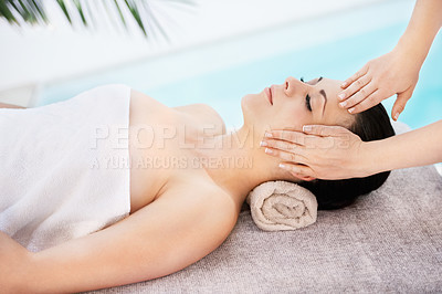 Buy stock photo A young woman getting a face massage from a massage therapist