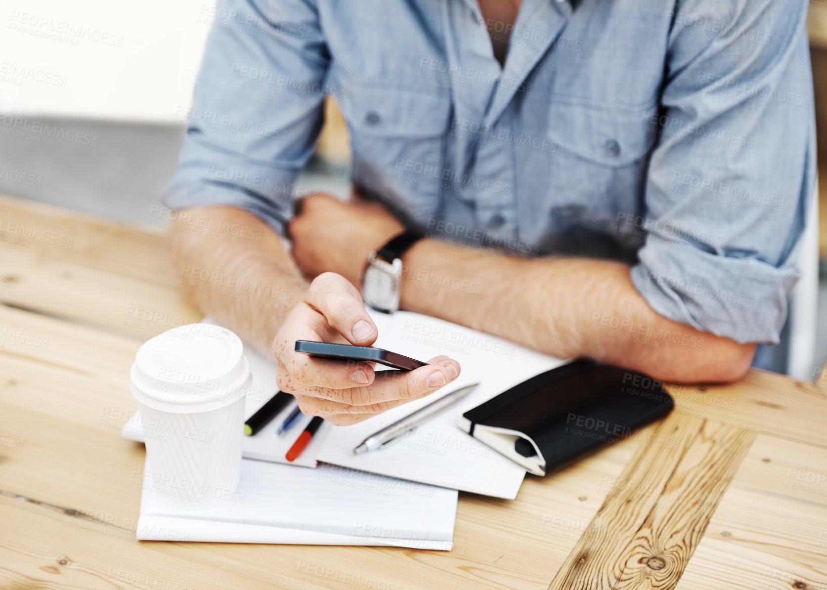 Buy stock photo Closeup of man typing on a cell phone, working remotely from an outdoor coffee shop. Person using a touchscreen device to send an email. Business man browsing the internet at his desk at work