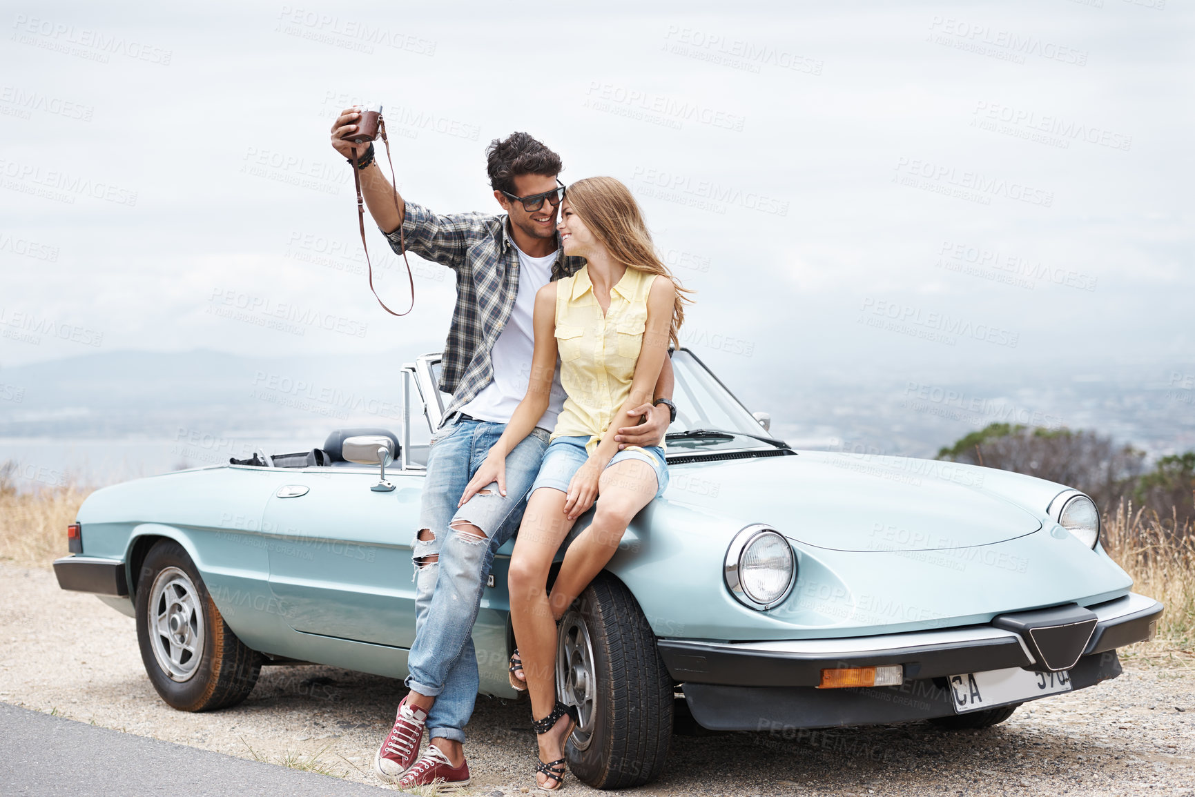 Buy stock photo Road trip, travel and couple in convertible in nature for freedom, vacation and happiness together. Summer, selfie and man with woman, smile and romance on drive in mountain countryside for transport