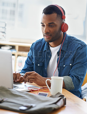 Buy stock photo A handsome casually dressed businessman working in his office