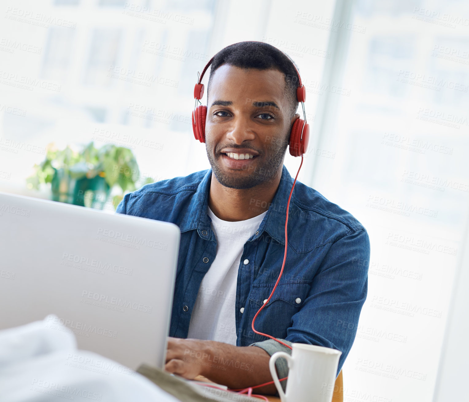 Buy stock photo A handsome casually dressed businessman working in his office